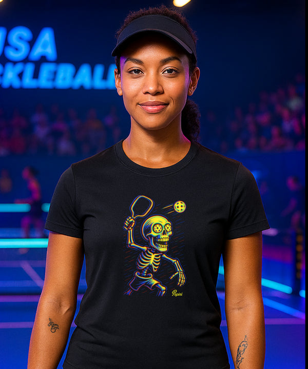 Person wearing a black t-shirt with a colorful skeleton design in front of a blurred background with text.