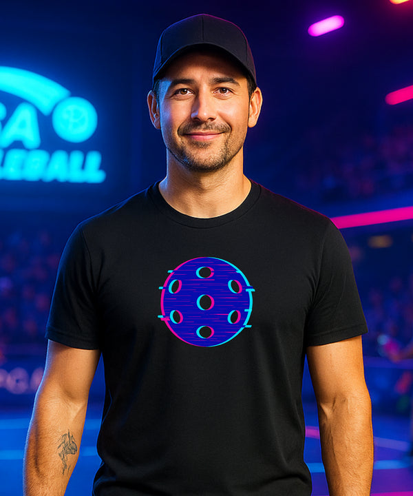 Man wearing a black t-shirt with a colorful design in front of a neon sign.