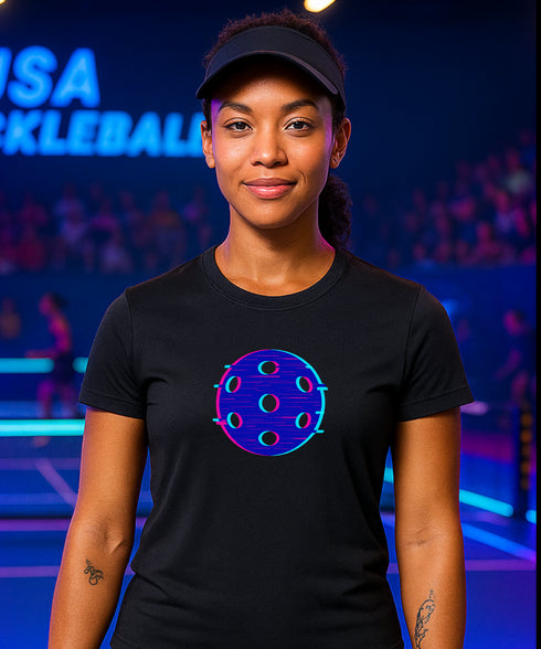 Person wearing a black t-shirt with a blue and purple design, standing in front of a colorful background.