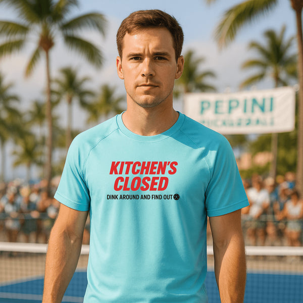 Man wearing a blue t-shirt with red text at a tennis court