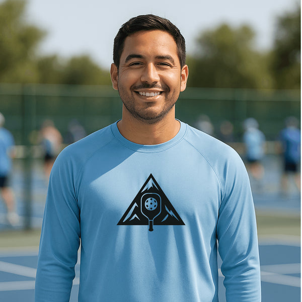 Man wearing a blue athletic shirt with a black logo on a sports court