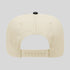 Beige cap with a black button on a light gray background