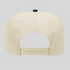 Beige cap with a black button on a light gray background