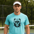 Man wearing a turquoise t-shirt with a dog graphic on a tennis court