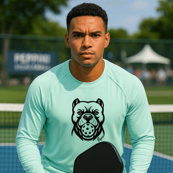 Man wearing a light blue shirt with a dog graphic on a tennis court