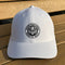 White cap with a black logo on a wooden surface