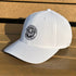 White cap with a logo on a wooden surface