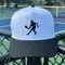 White and black cap with a tennis player silhouette on a tennis court background