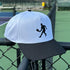 White and black cap with a tennis player silhouette on a tennis court background