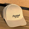Beige cap with 'Pickleball Est. 1965' text on a wooden surface
