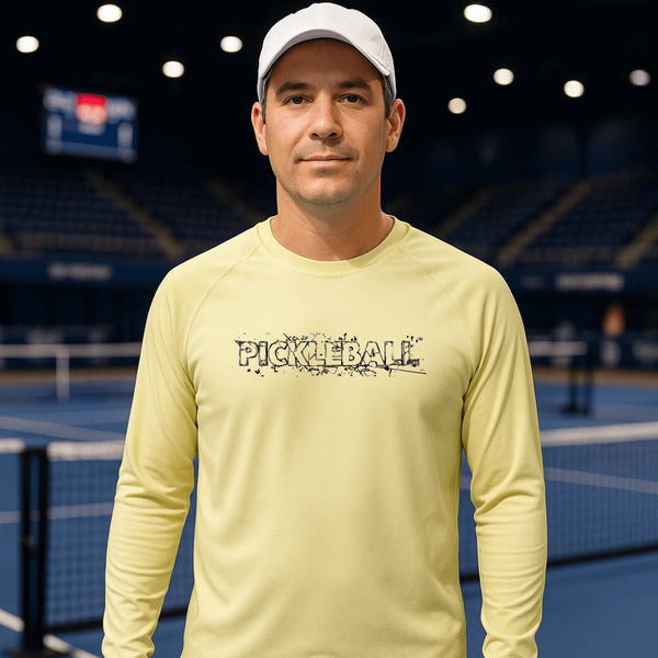 Man wearing a yellow 'Pickleball' shirt on a tennis court