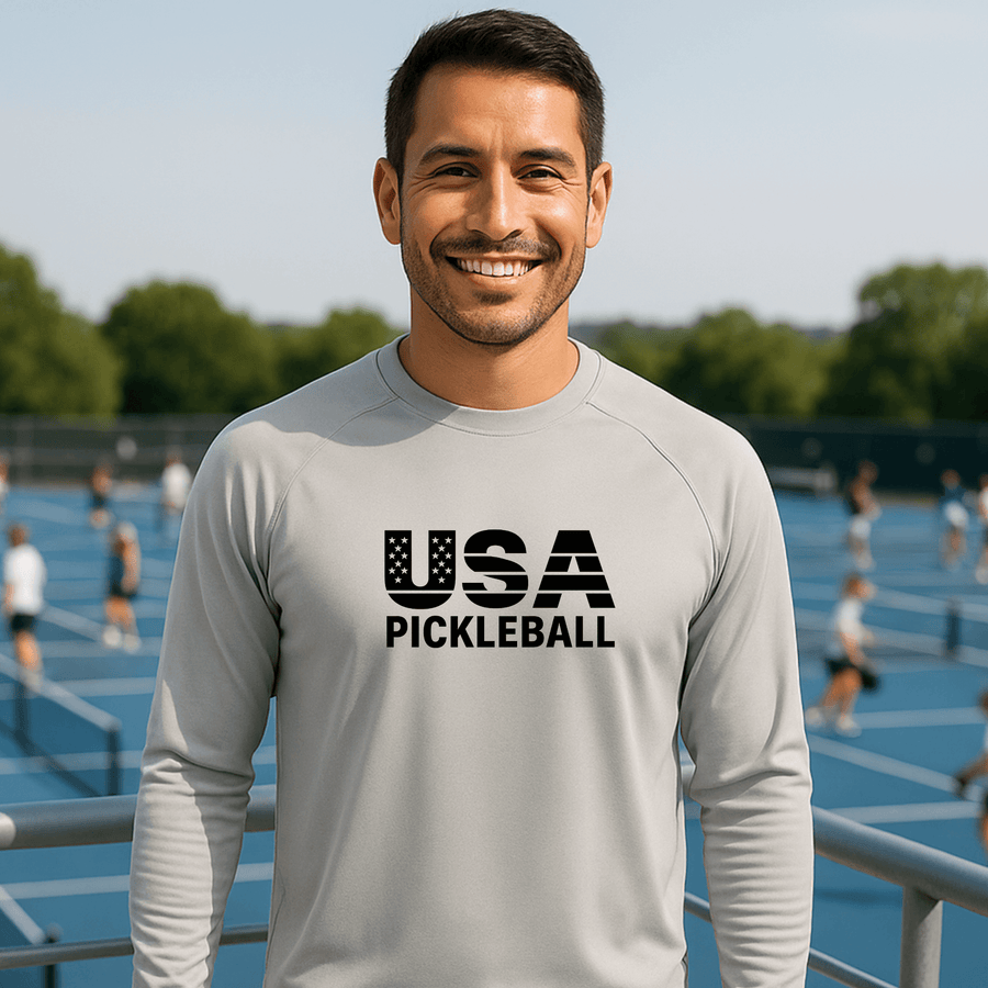 Man wearing a 'USA Pickleball' shirt on a pickleball court